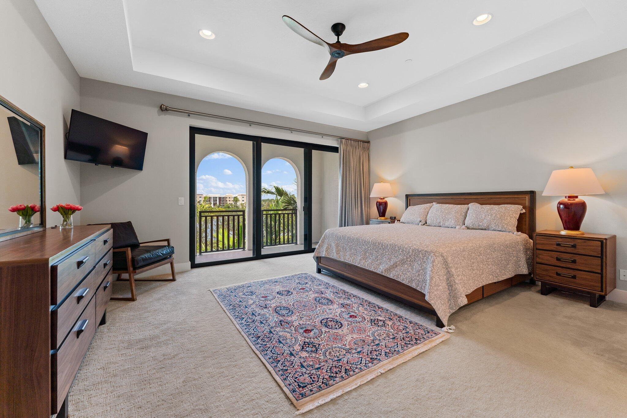 13364 Alton Road Palm Beach Gardens, FL 33418 - Photo 26 of 58 a bedroom with a large bed and a flat tv screen