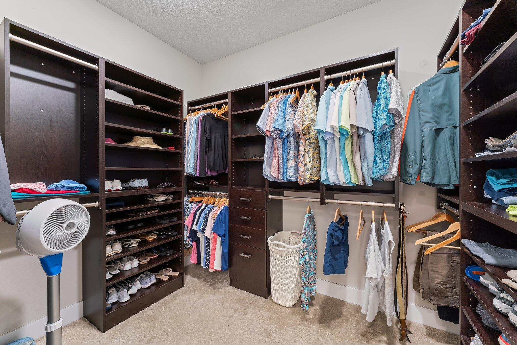 13364 Alton Road Palm Beach Gardens, FL 33418 - Photo 31 of 58 a view of walk in closet with clothes and shoes
