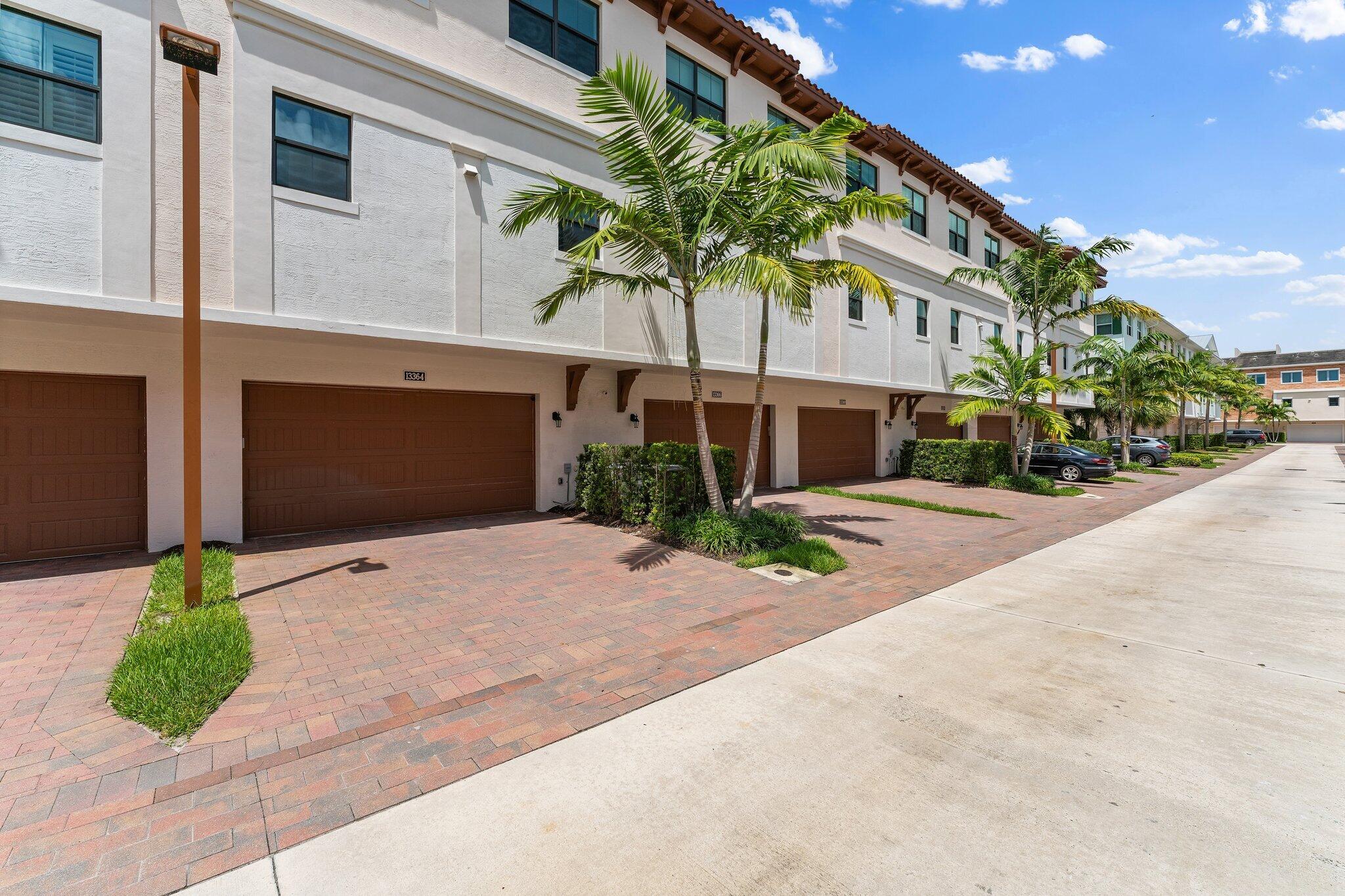 13364 Alton Road Palm Beach Gardens, FL 33418 - Photo 33 of 58 a front view of a house with garden and parking