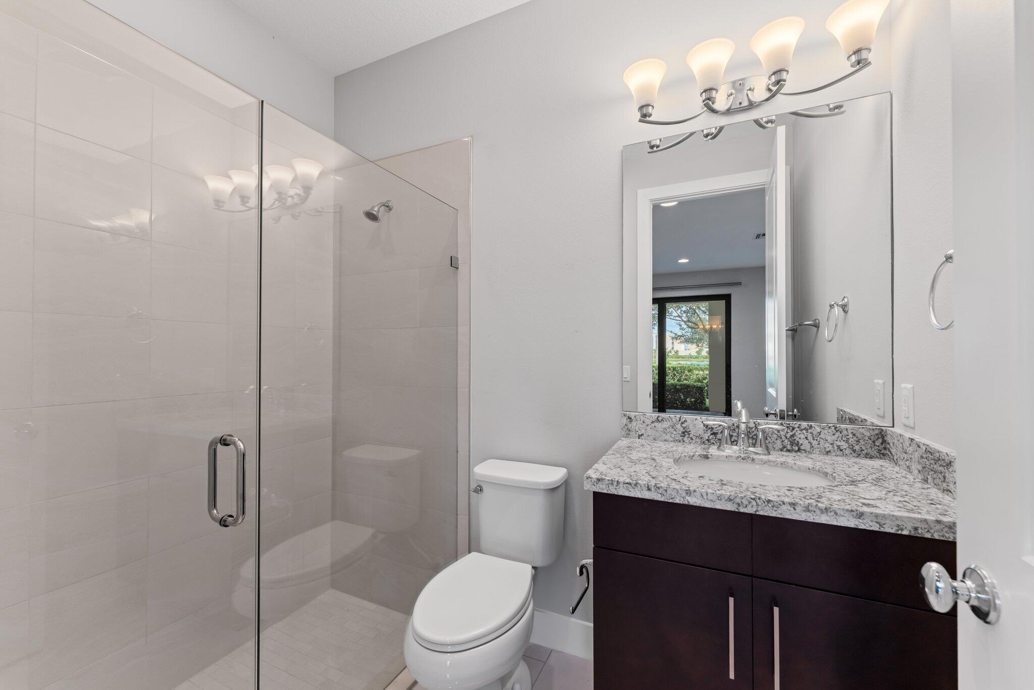 13364 Alton Road Palm Beach Gardens, FL 33418 - Photo 10 of 58 a bathroom with a granite countertop sink toilet and shower