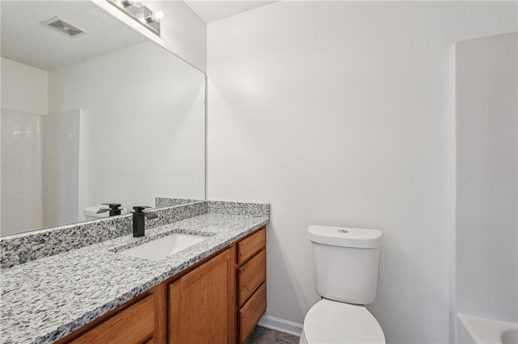 38 Middleton Court Cartersville, GA 30120 - Photo 26 of 46 a bathroom with a granite countertop sink and a mirror
