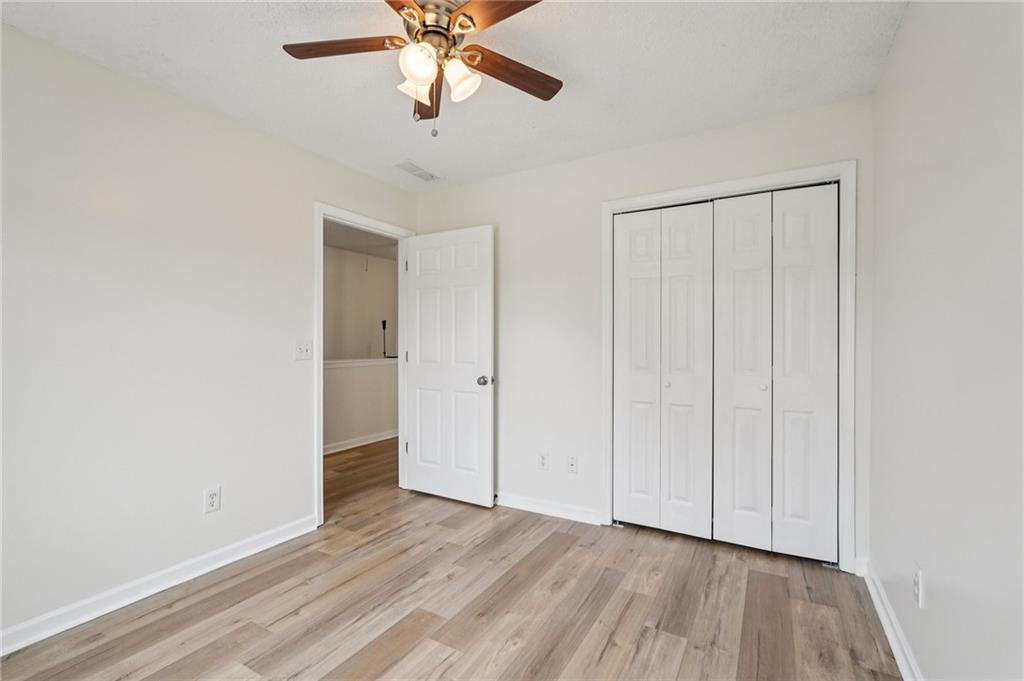 38 Middleton Court Cartersville, GA 30120 - Photo 35 of 46 an empty room with wooden floor chandelier fan and closet area