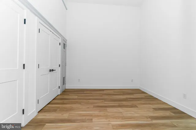 a view of a room with wooden floor