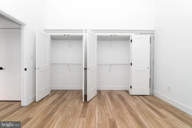 a view of a room with wooden floor