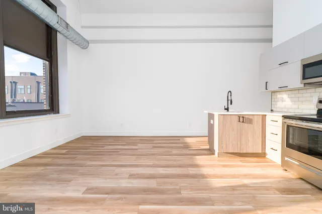a view of a kitchen with microwave and cabinets