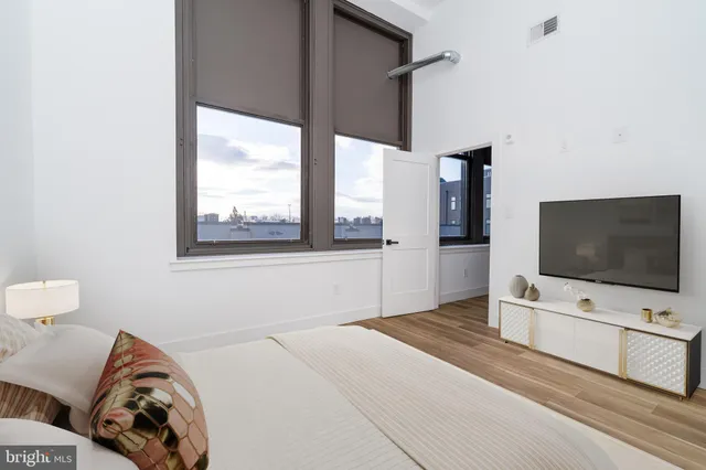 a bedroom with bed and tv