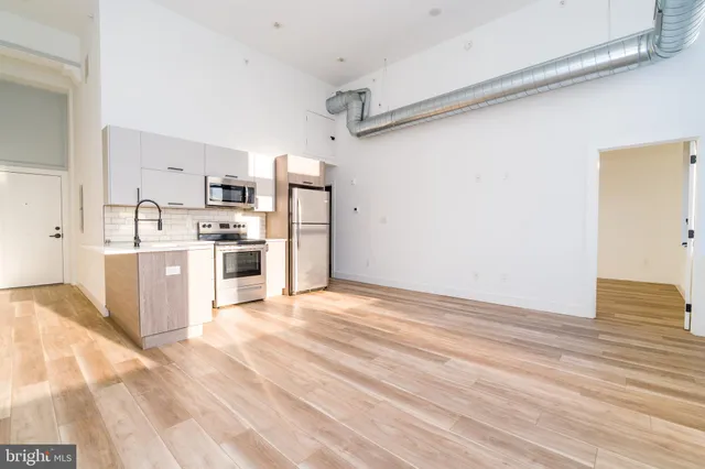 a view of a kitchen with wooden cabinet