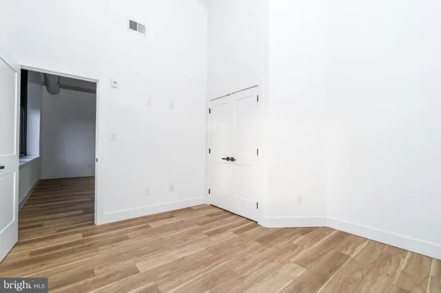 a view of a room with wooden floor