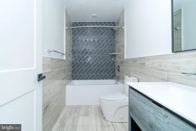 a bathroom with a sink a toilet and bathtub