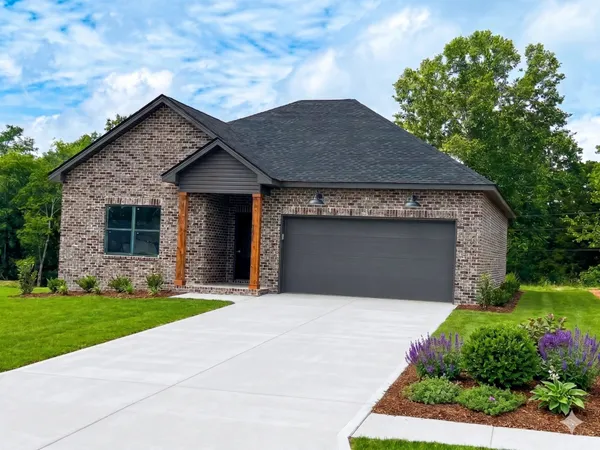 a front view of a house with garage and yard