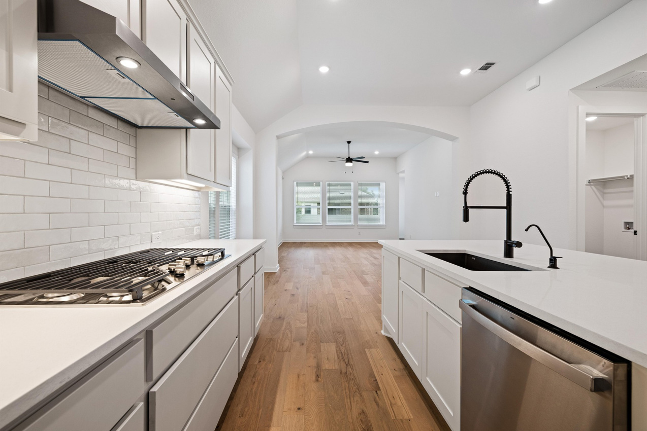 120 Fox Run Georgetown, TX 78628 - Photo 7 of 30 a kitchen with granite countertop a stove and a sink