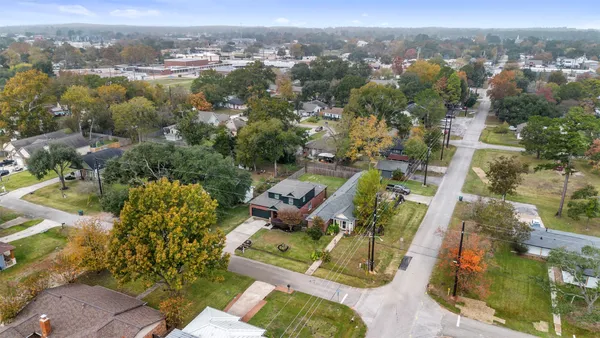 an aerial view of a house with a yard