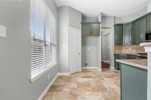 a view of a kitchen with a sink and a window