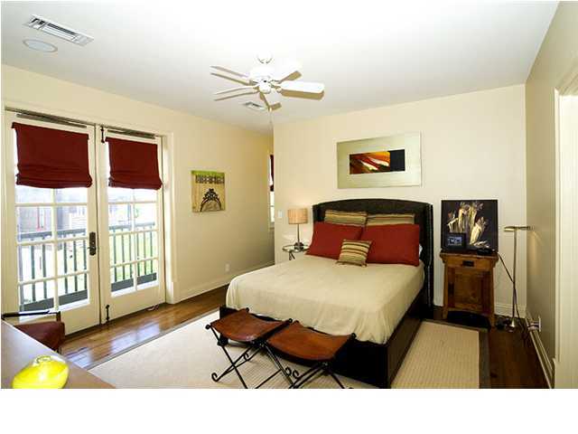 34 The Lofts In Barrett Square, Unit 2E Rosemary Beach, FL 32461 - Photo 5 of 12 a bedroom with a bed and wooden floor
