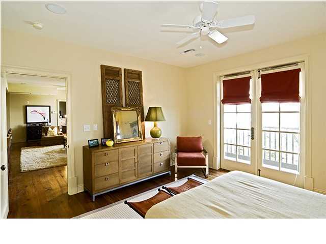 34 The Lofts In Barrett Square, Unit 2E Rosemary Beach, FL 32461 - Photo 6 of 12 a bedroom with a bed and wooden floor