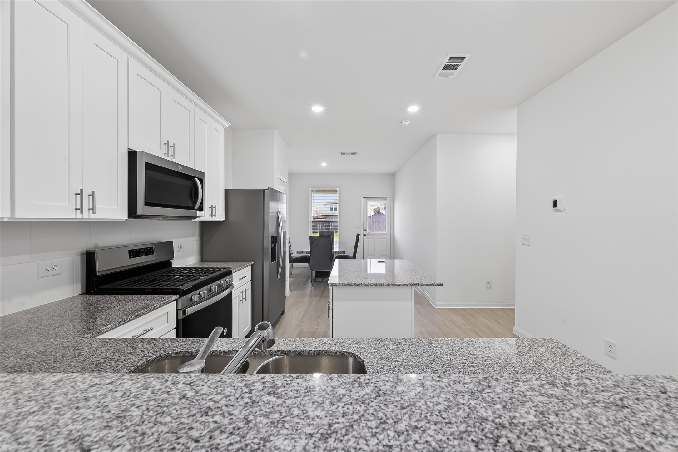 17902 Slurry Rake Lane Hockley, TX 77447 - Photo 7 of 32 a view of a kitchen with a sink stainless steel appliances cabinets and a counter top space