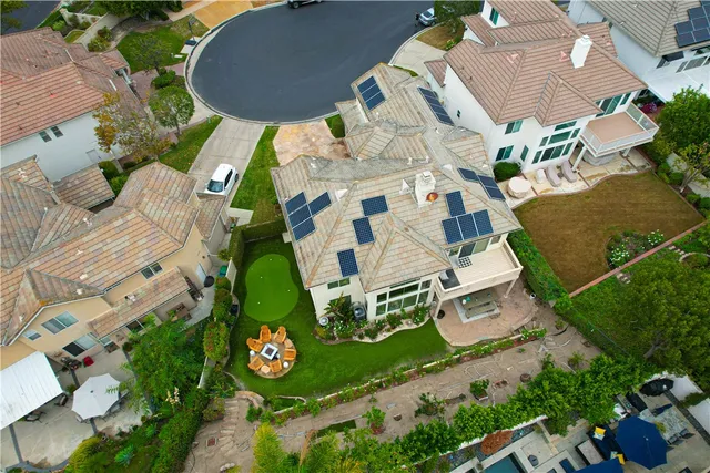 an aerial view of a house with garden space and street view