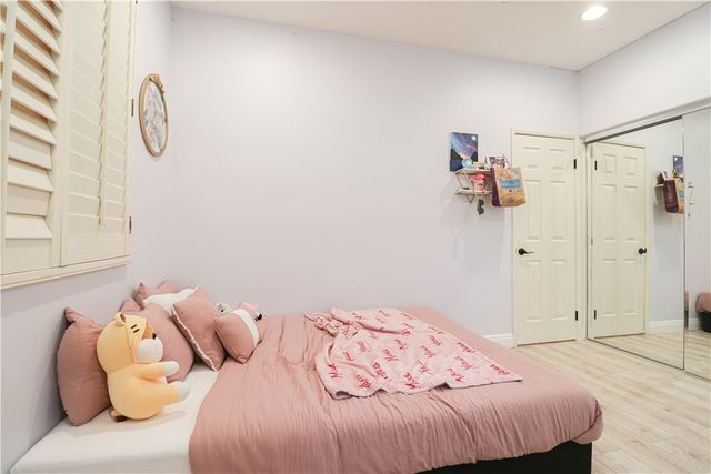 a bedroom with a bed and a closet