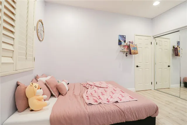 a bedroom with a bed and a closet