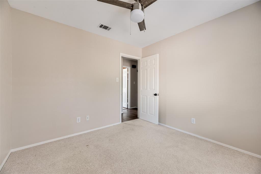 11136 McCree Road Dallas, TX 75238 - Photo 11 of 21 an empty room with an entryway and chandelier