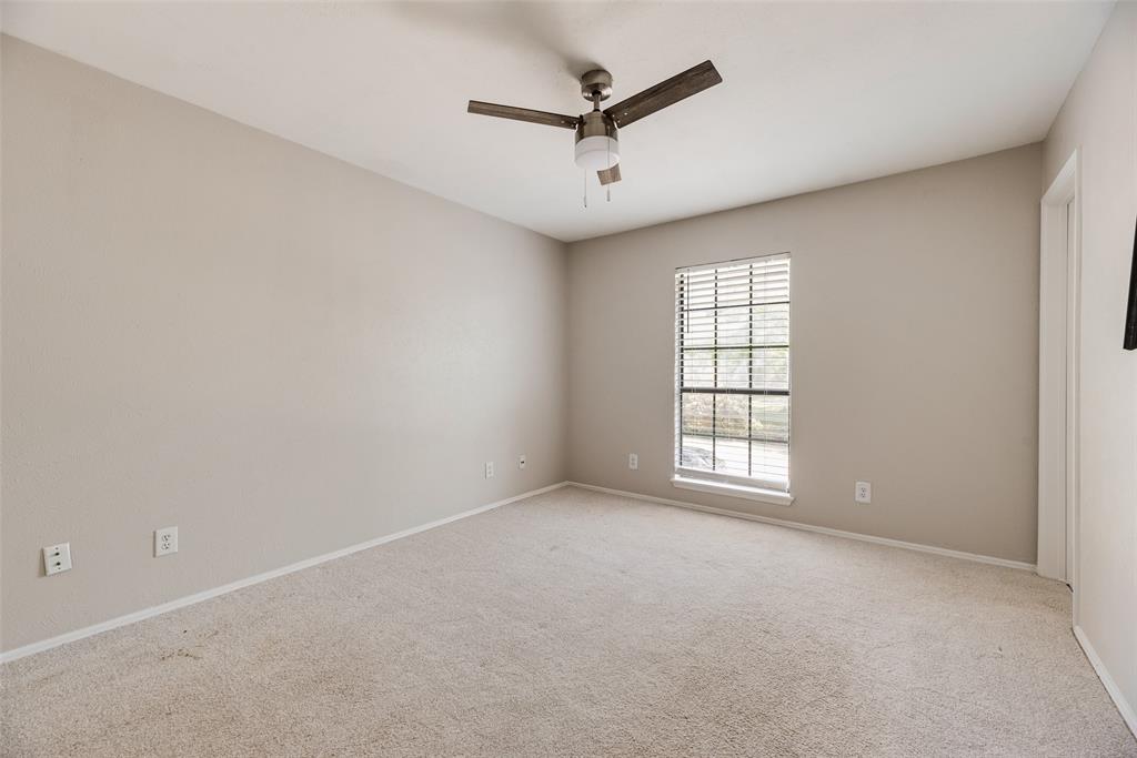 11136 McCree Road Dallas, TX 75238 - Photo 12 of 21 an empty room with windows and fan