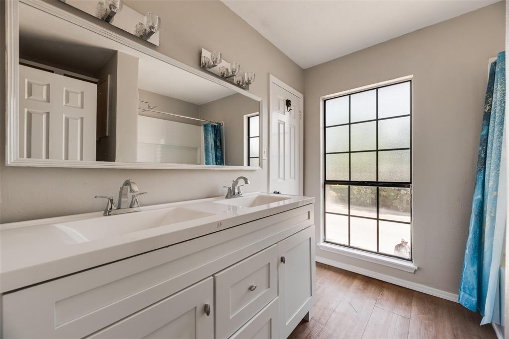 11136 McCree Road Dallas, TX 75238 - Photo 15 of 21 a bathroom with a sink and a window