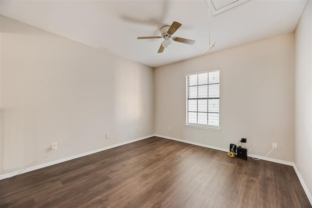 11136 McCree Road Dallas, TX 75238 - Photo 17 of 21 an empty room with wooden floor fan and windows