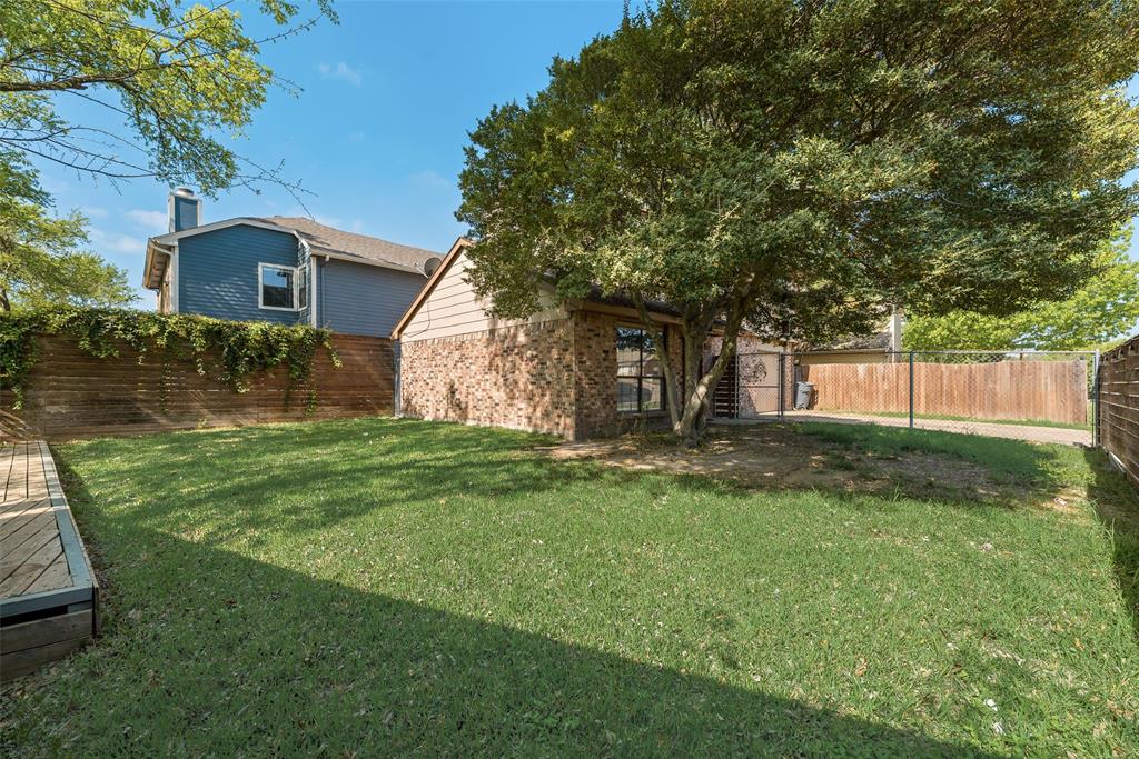 11136 McCree Road Dallas, TX 75238 - Photo 19 of 21 a front view of a house with yard and green space