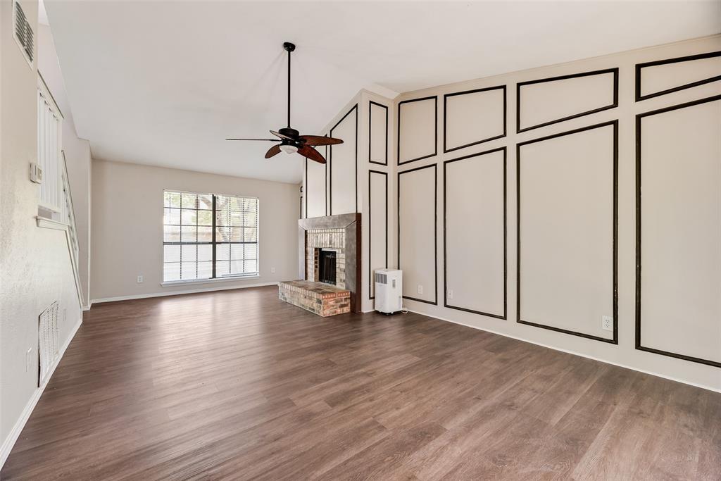 11136 McCree Road Dallas, TX 75238 - Photo 7 of 21 a view of an empty room with wooden floor and a window