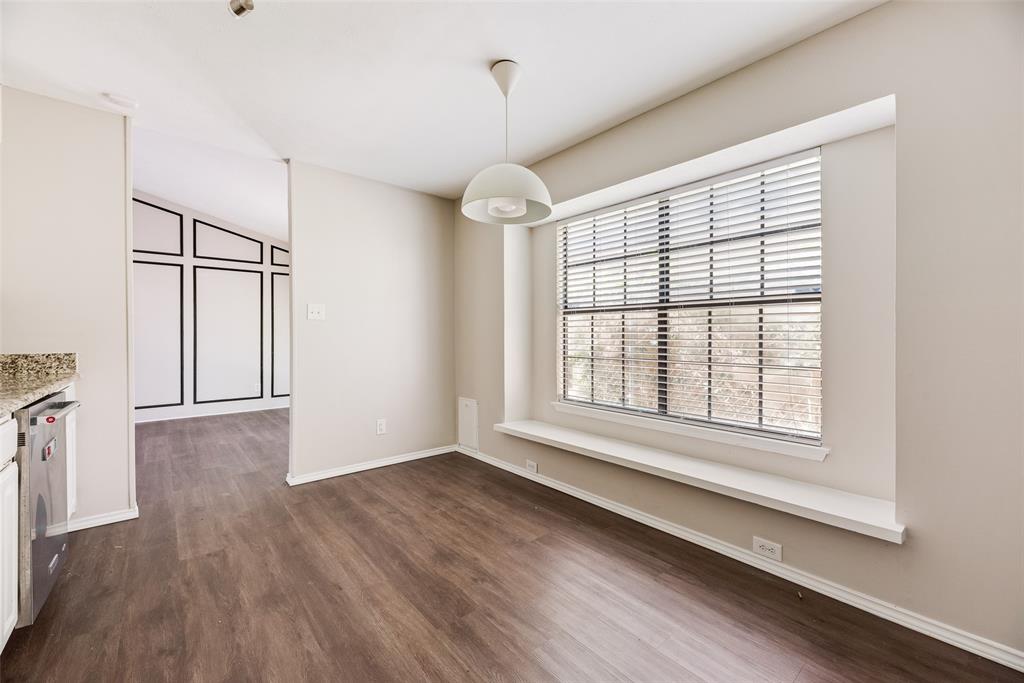 11136 McCree Road Dallas, TX 75238 - Photo 8 of 21 a view of an empty room with wooden floor and a window