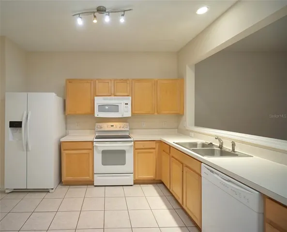 a kitchen with a stove sink and refrigerator