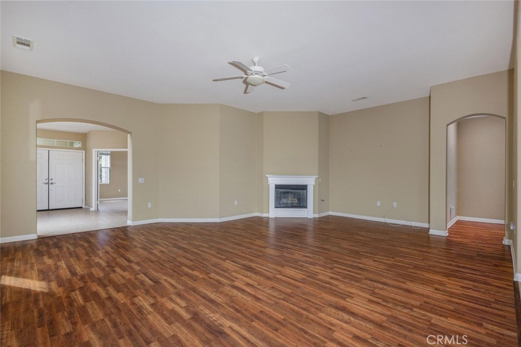7692 Dutra Drive Hemet, CA 92545 - Photo 15 of 48 a view of empty room with wooden floor and fan