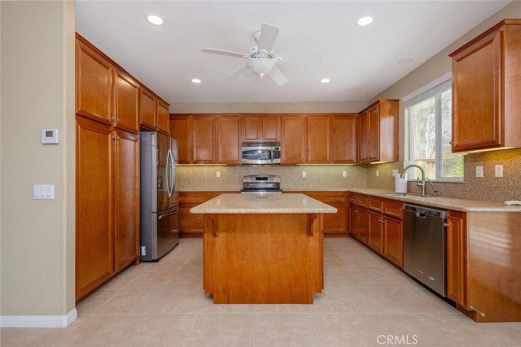 7692 Dutra Drive Hemet, CA 92545 - Photo 17 of 48 a kitchen with stainless steel appliances granite countertop a sink stove and refrigerator