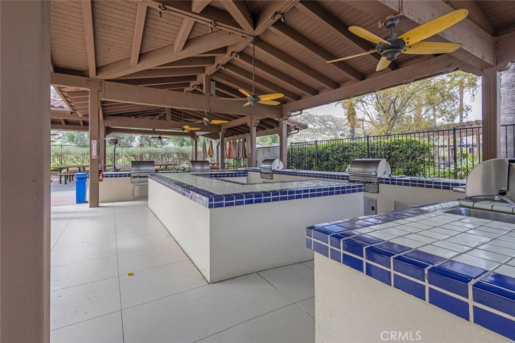 7692 Dutra Drive Hemet, CA 92545 - Photo 40 of 48 a dining table with a rug floor to ceiling window and outdoor view