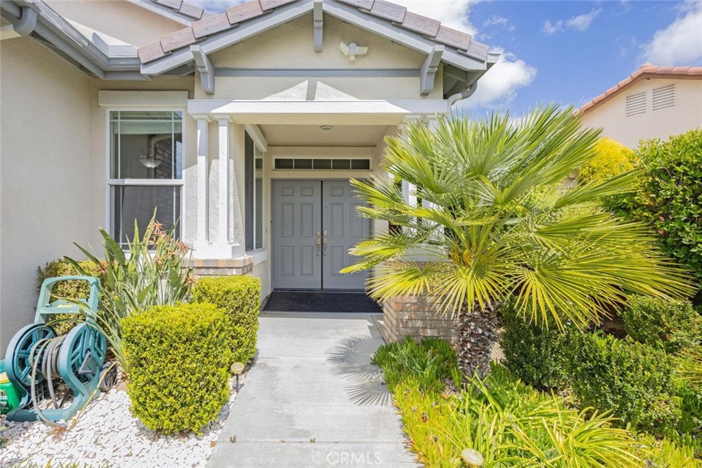 7692 Dutra Drive Hemet, CA 92545 - Photo 5 of 48 a front view of a house with a garden