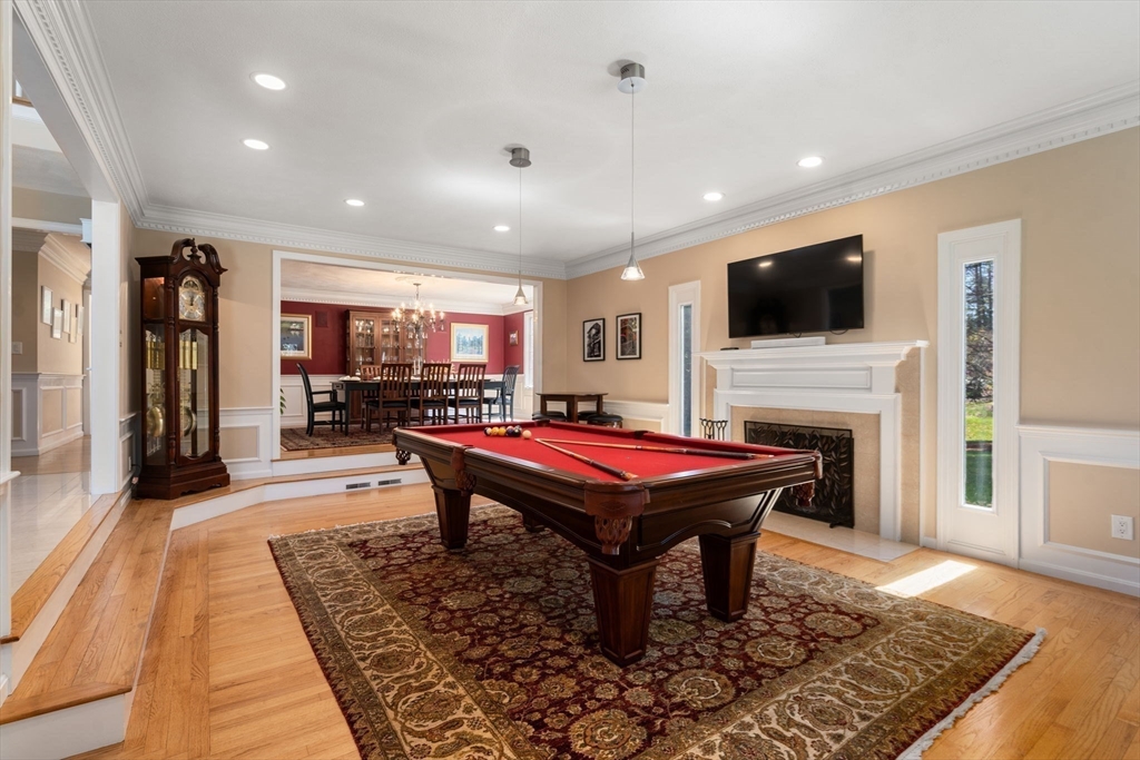 22 Fox Run Road Sudbury, MA 01776 - Photo 14 of 42 a living room with a flat screen tv and a fireplace