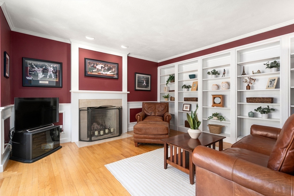 22 Fox Run Road Sudbury, MA 01776 - Photo 15 of 42 a living room with furniture a flat screen tv and a fireplace