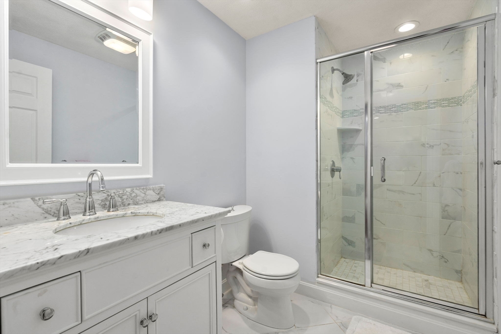 22 Fox Run Road Sudbury, MA 01776 - Photo 24 of 42 a bathroom with a granite countertop sink toilet and shower