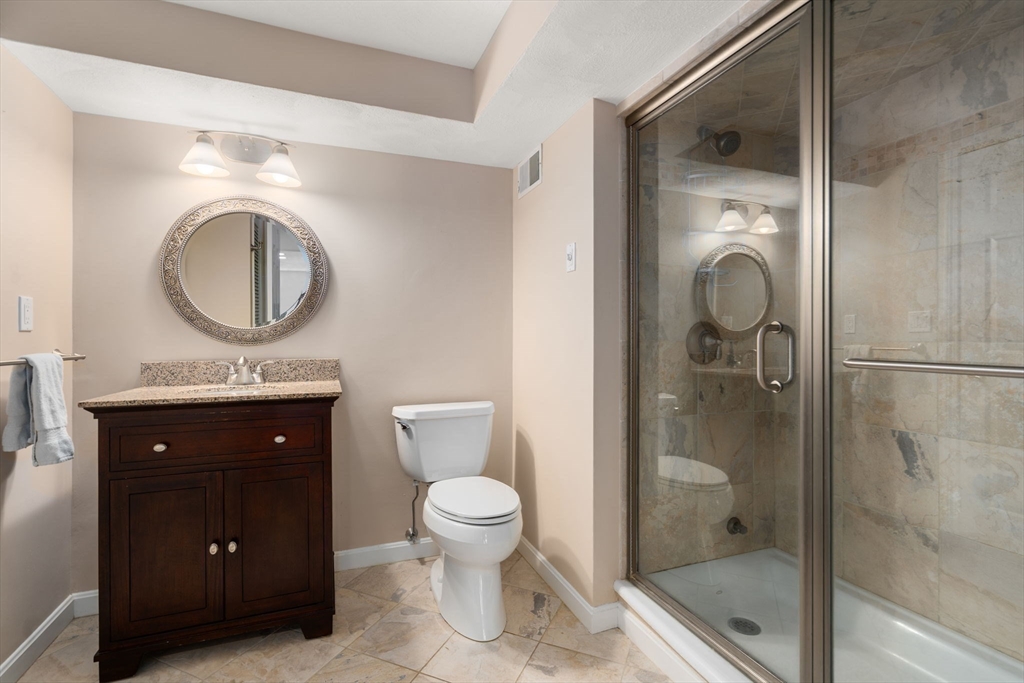 22 Fox Run Road Sudbury, MA 01776 - Photo 32 of 42 a bathroom with a toilet a sink and mirror