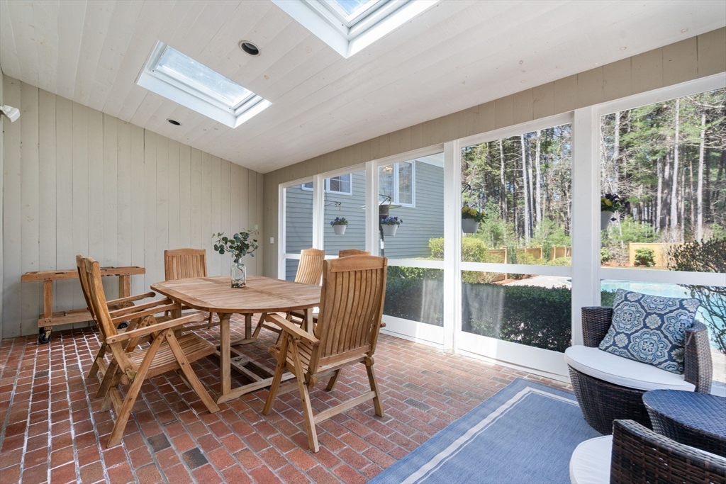 22 Fox Run Road Sudbury, MA 01776 - Photo 33 of 42 a view of a dining room with furniture large windows and wooden floor