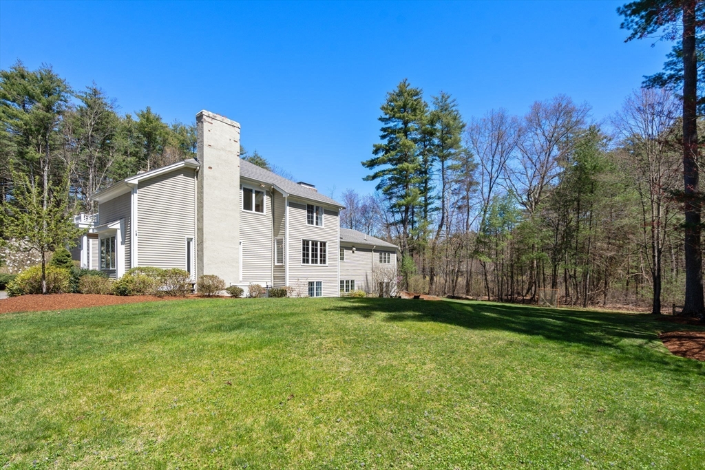 22 Fox Run Road Sudbury, MA 01776 - Photo 39 of 42 a big white house with a big yard and large trees