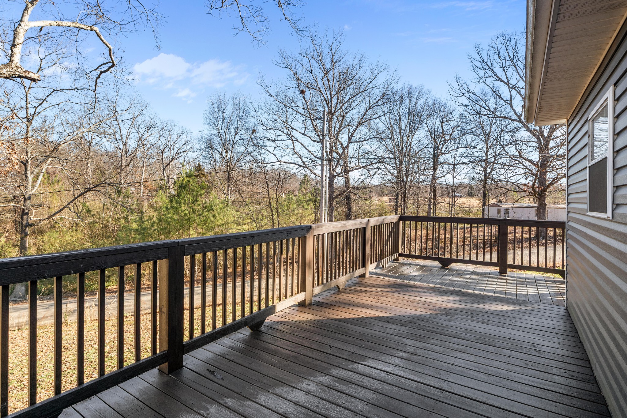 358 Able Street Big Sandy, TN 38221 - Photo 12 of 31 a view of a wooden street from a roof deck