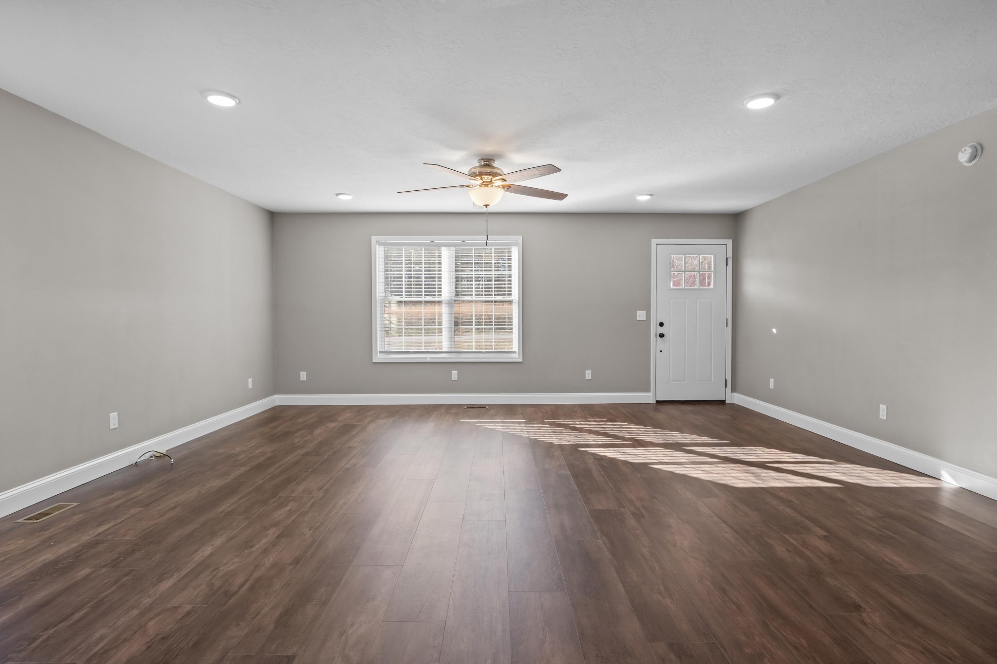 358 Able Street Big Sandy, TN 38221 - Photo 14 of 31 an empty room with wooden floor and windows