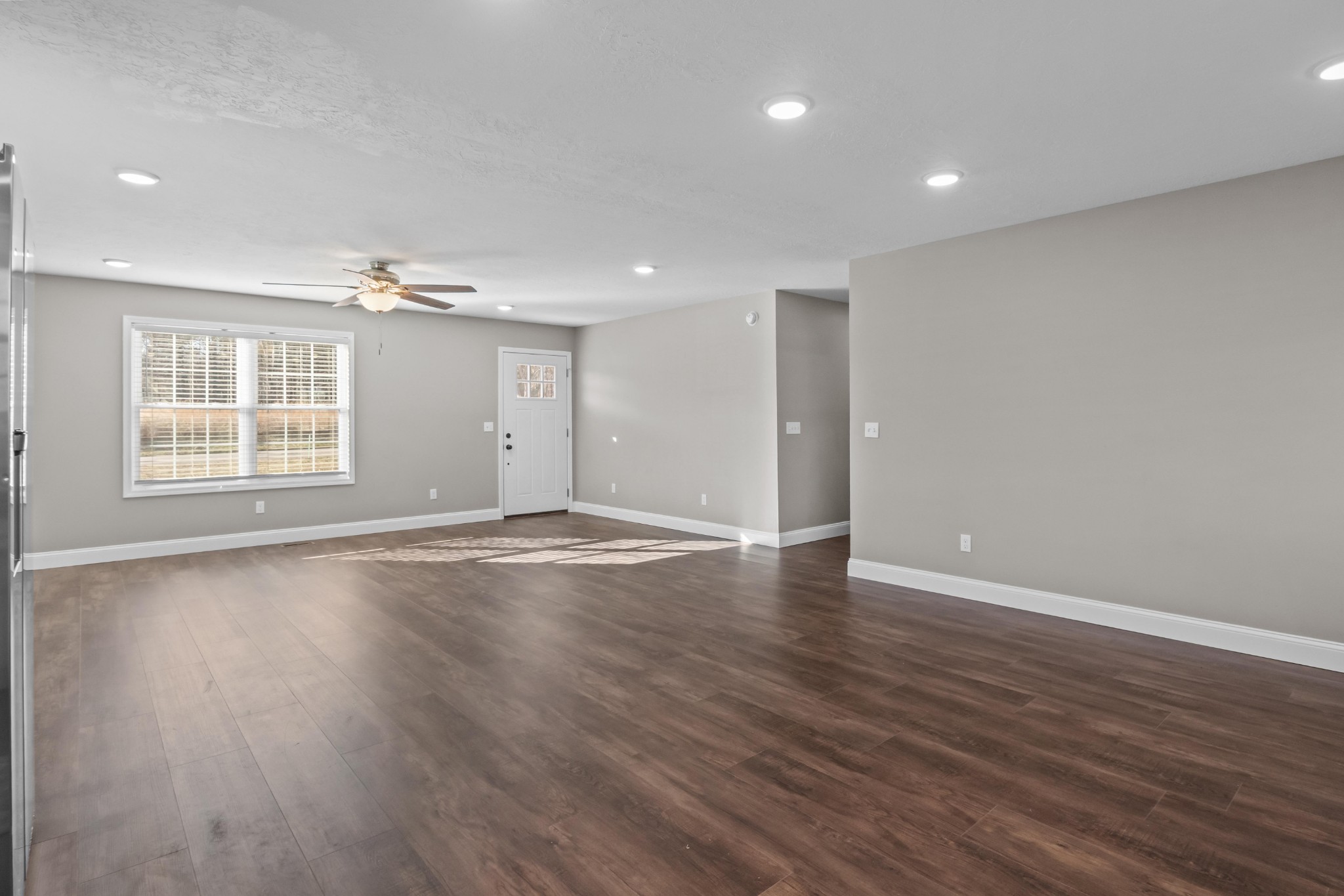 358 Able Street Big Sandy, TN 38221 - Photo 17 of 31 an empty room with wooden floor and windows