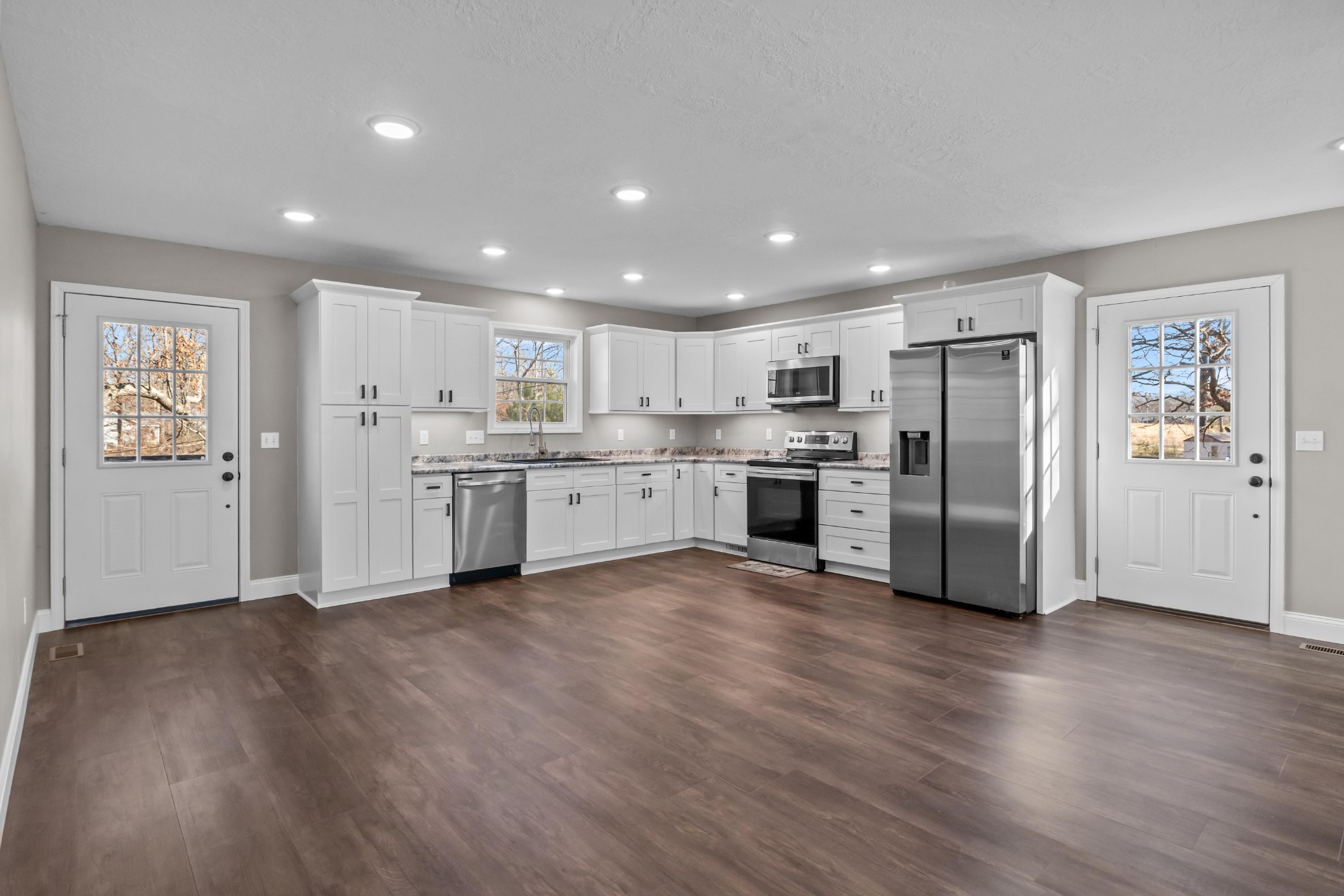 358 Able Street Big Sandy, TN 38221 - Photo 18 of 31 a kitchen with stainless steel appliances granite countertop a refrigerator and a stove top oven