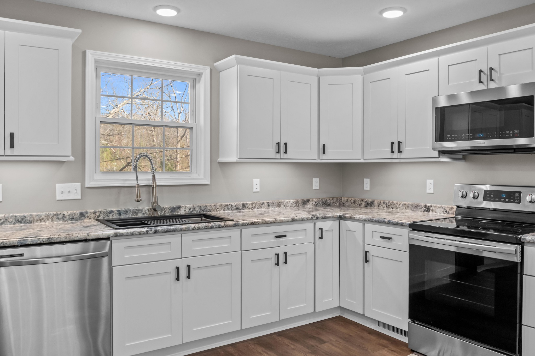 358 Able Street Big Sandy, TN 38221 - Photo 19 of 31 a kitchen with stainless steel appliances granite countertop a sink and a stove
