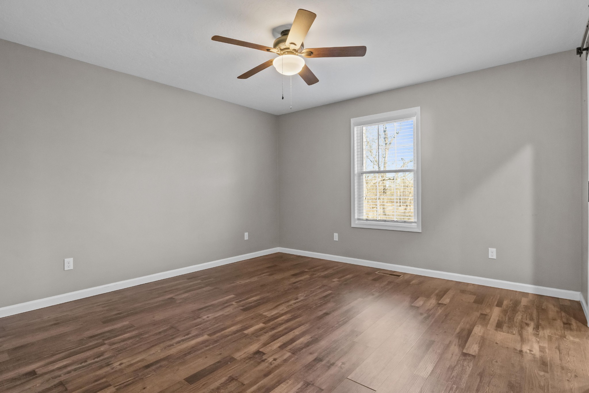 358 Able Street Big Sandy, TN 38221 - Photo 20 of 31 wooden floor in an empty room with a window