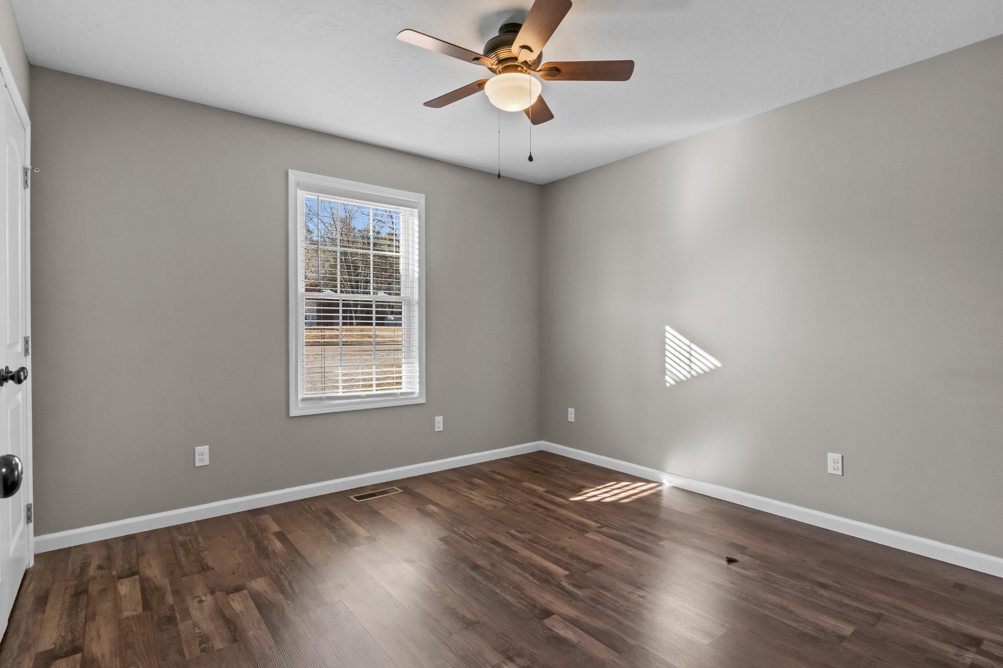 358 Able Street Big Sandy, TN 38221 - Photo 25 of 31 wooden floor in an empty room with a window