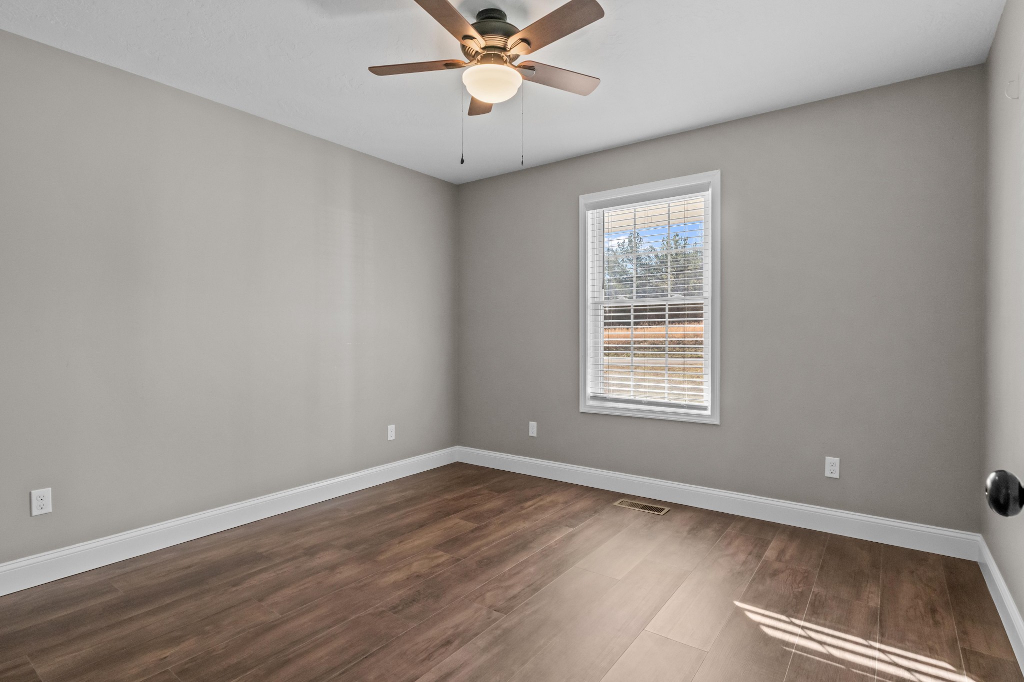 358 Able Street Big Sandy, TN 38221 - Photo 28 of 31 a view of a room with wooden floor and fan