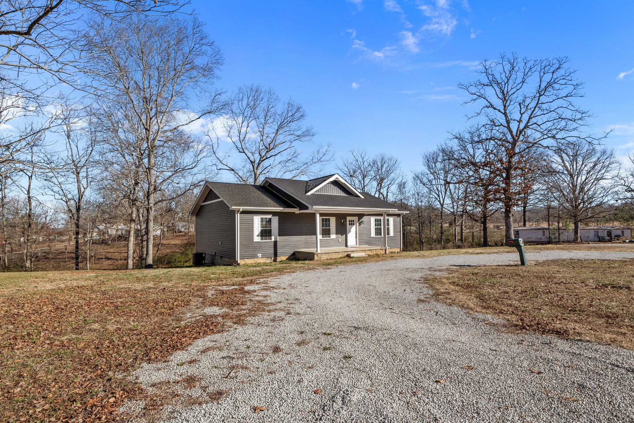 358 Able Street Big Sandy, TN 38221 - Photo 7 of 31 a white house that has a tree in front of it